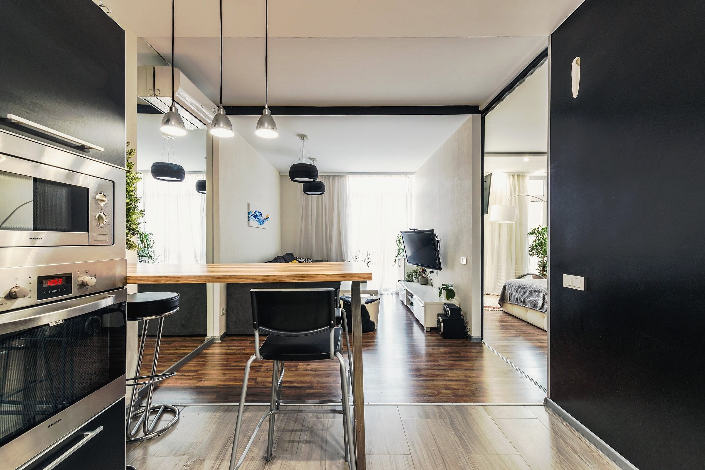 An open kitchen with built-in appliances in a spacious modern apartment.