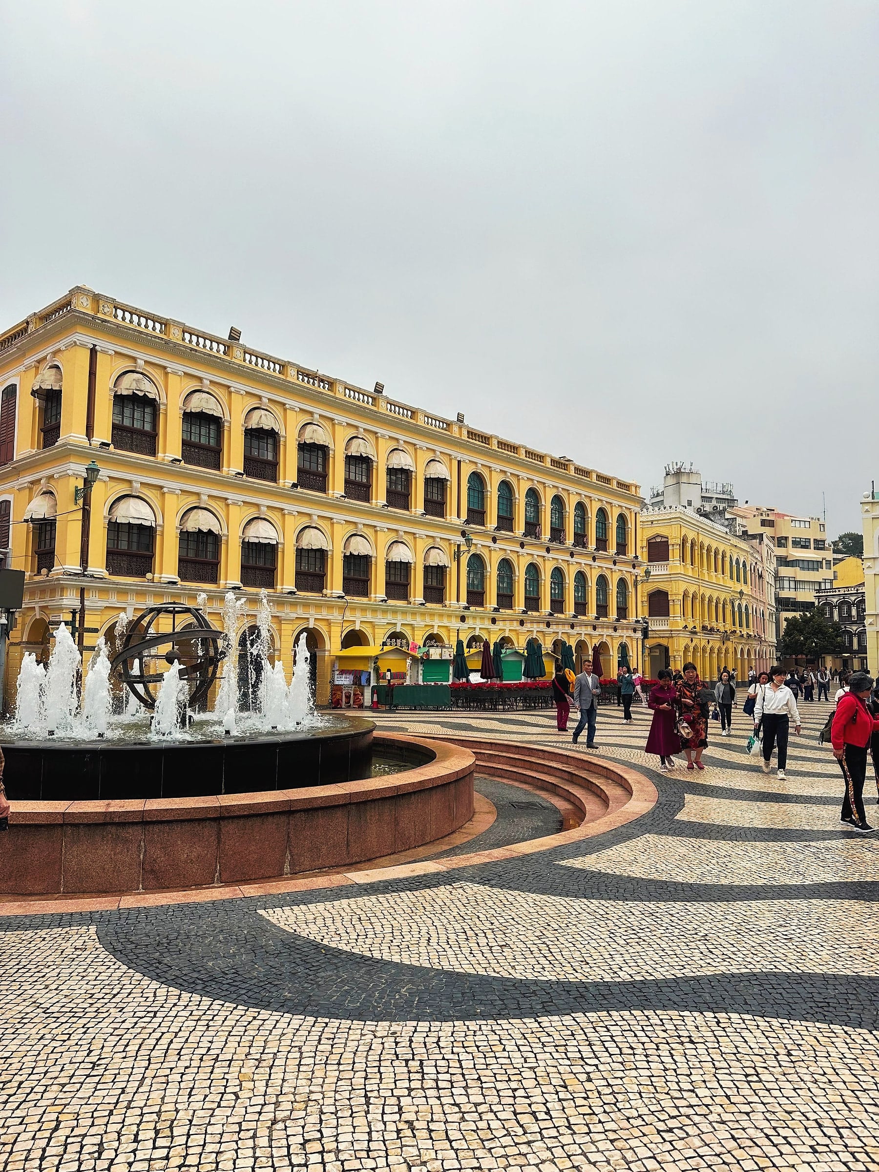 Senado Square in Macau, with its wave-patterned Portuguese pavement and pastel colonial buildings.