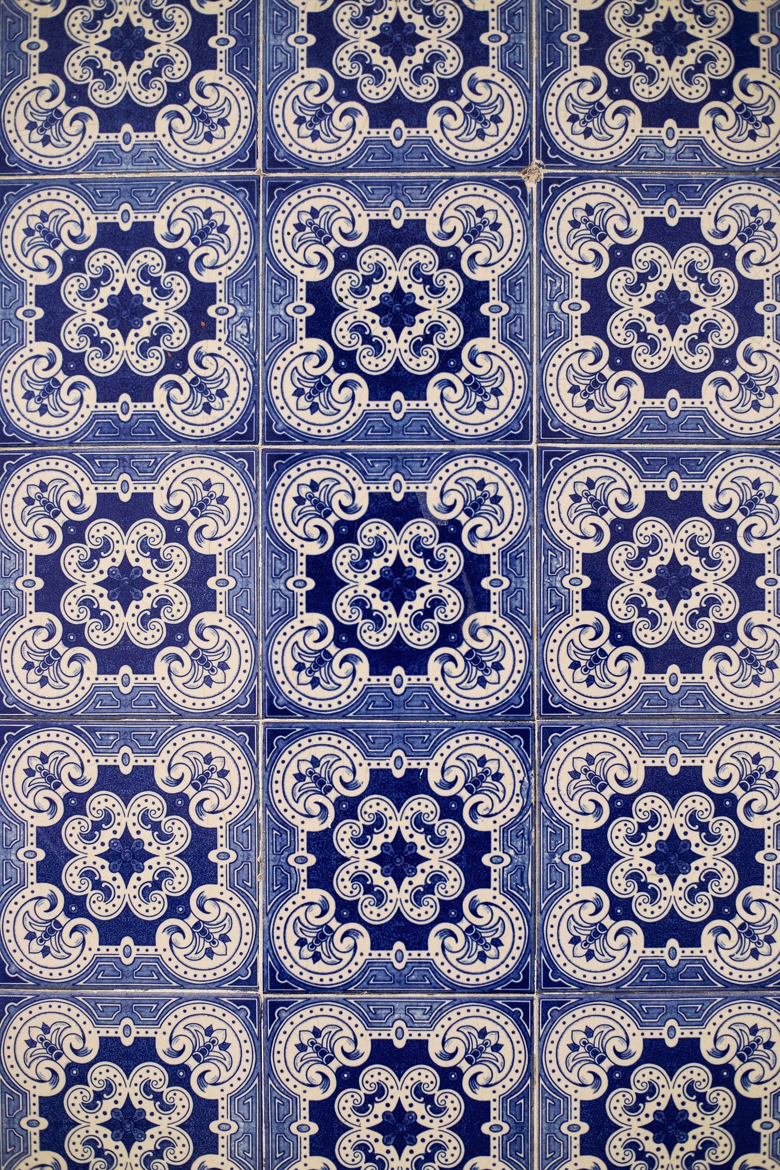 Blue and white Portuguese azulejo tiles with a repeating pattern.